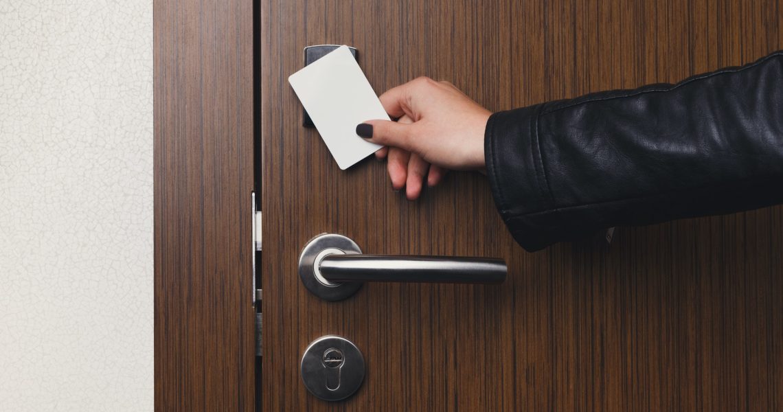 Hand inserting key card in electronic lock